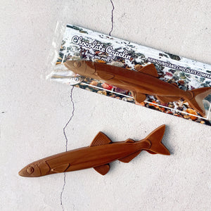 MILK CHOCOLATE CAPELIN, ONLY  AVAILABLE FOR PURCHASE IN OUR RETAIL STORES.